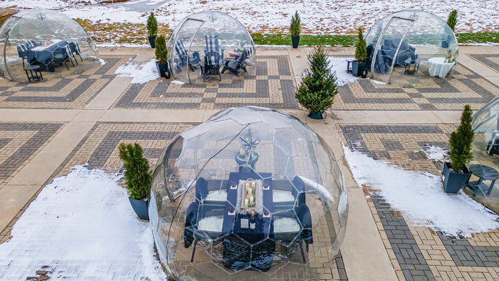 Aerial view of Skye Chase Winter Wine Domes on snowy patio